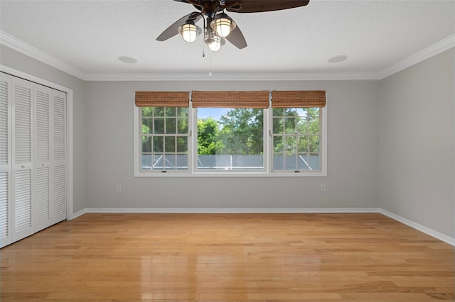 7268 Crystal Spring Run, Weeki Wachee, FL 34607 - unfurnished bedroom with multiple windows, ornamental molding, light wood-style flooring, a textured ceiling, and a closet