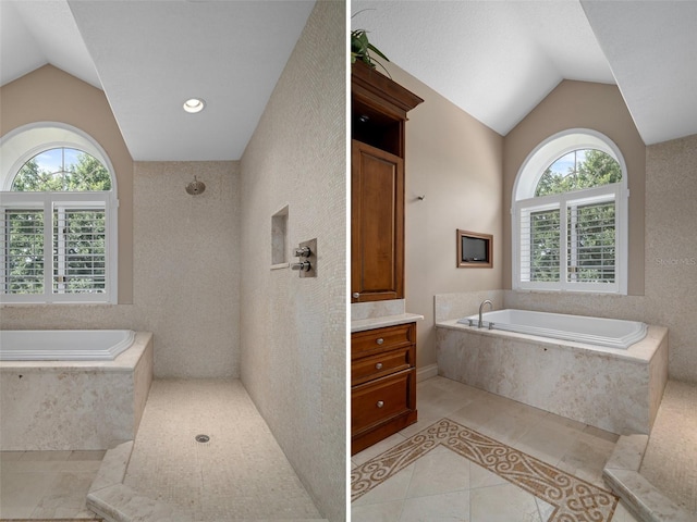7268 Crystal Spring Run, Weeki Wachee, FL 34607 - full bathroom featuring lofted ceiling, tile patterned flooring, a garden tub, vanity, and a shower