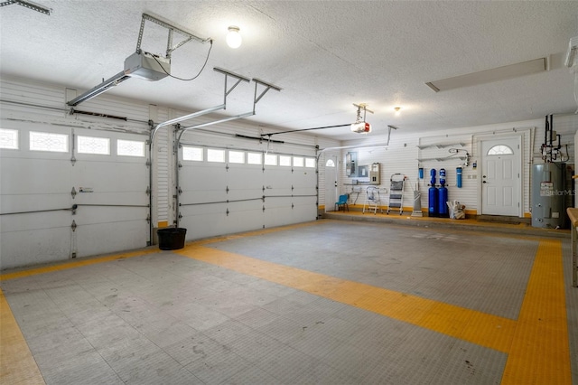 7268 Crystal Spring Run, Weeki Wachee, FL 34607 - garage featuring a garage door opener and water heater