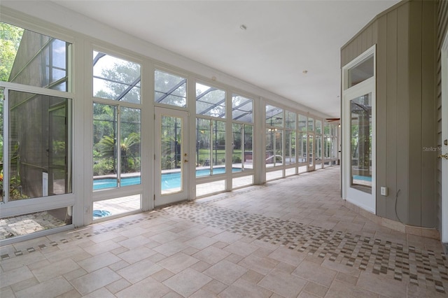 7268 Crystal Spring Run, Weeki Wachee, FL 34607 - unfurnished sunroom featuring stone finish flooring