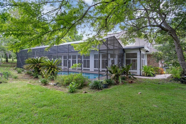 7268 Crystal Spring Run, Weeki Wachee, FL 34607 - back of property with a lawn, an outdoor pool, and a lanai