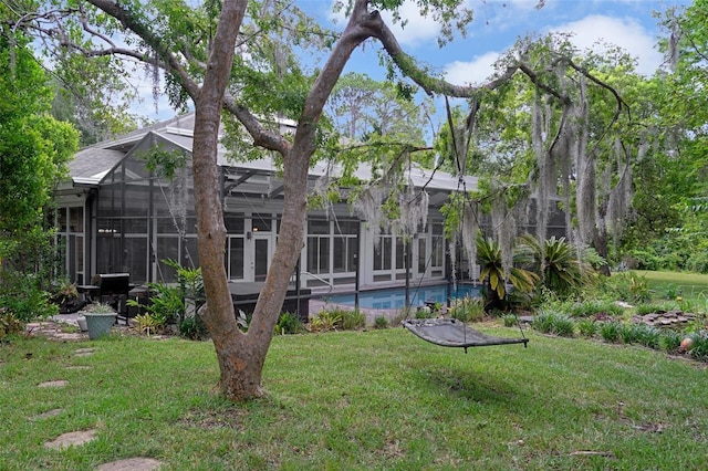 7268 Crystal Spring Run, Weeki Wachee, FL 34607 - rear view of house featuring a lawn, a lanai, and an outdoor pool