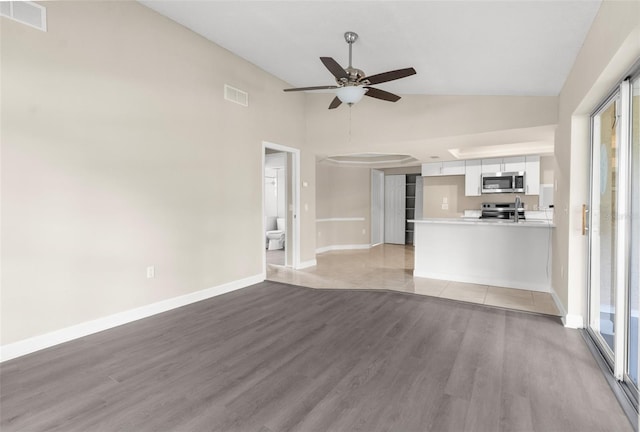 6509 Pine Meadows Dr, Spring Hill, FL 34606 - unfurnished living room with light wood-style floors, a ceiling fan, and high vaulted ceiling