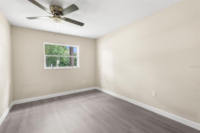 6509 Pine Meadows Dr, Spring Hill, FL 34606 - unfurnished room featuring wood finished floors, a ceiling fan, and a textured ceiling