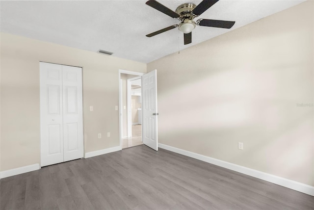 6509 Pine Meadows Dr, Spring Hill, FL 34606 - unfurnished bedroom featuring wood finished floors, a closet, and ceiling fan