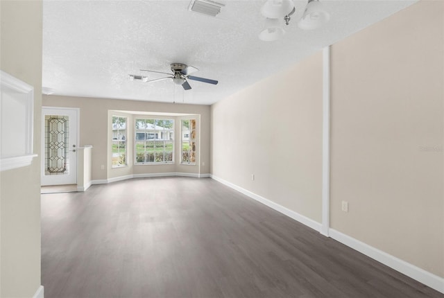 6509 Pine Meadows Dr, Spring Hill, FL 34606 - unfurnished living room with wood finished floors, a ceiling fan, and a textured ceiling