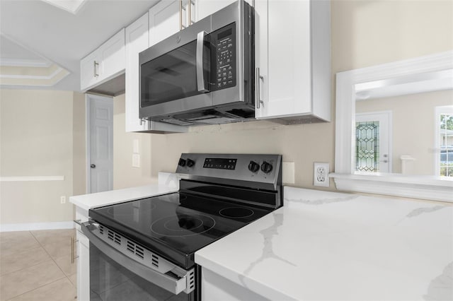 6509 Pine Meadows Dr, Spring Hill, FL 34606 - kitchen featuring stainless steel appliances, white cabinetry, light stone counters, and light tile patterned flooring