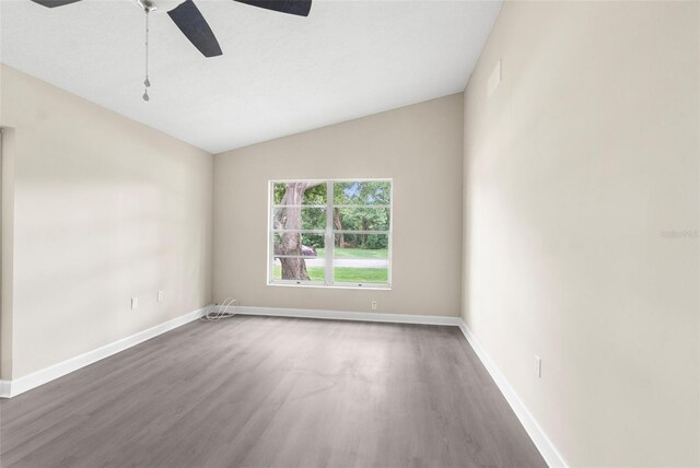 6509 Pine Meadows Dr, Spring Hill, FL 34606 - spare room with wood finished floors, ceiling fan, and lofted ceiling