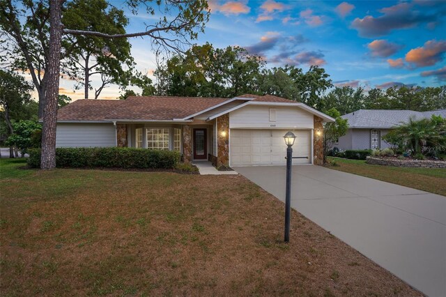 6509 Pine Meadows Dr, Spring Hill, FL 34606 - single story home featuring a garage, a front yard, driveway, and stone siding