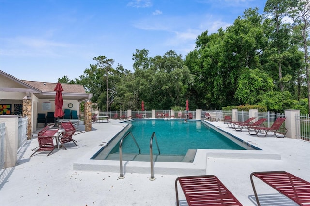 6509 Pine Meadows Dr, Spring Hill, FL 34606 - community pool with a patio area and view of scattered trees