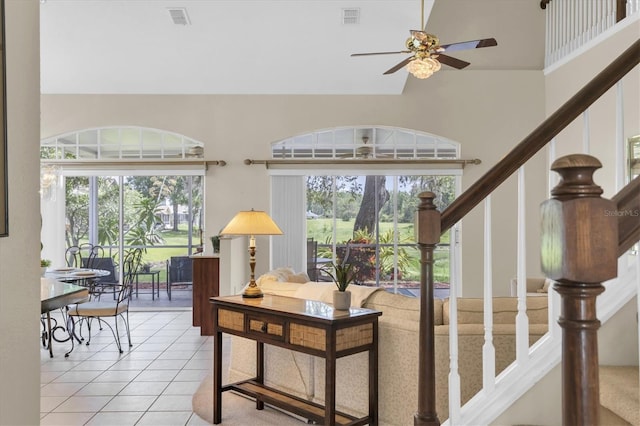 11418 Tee Time Cir, New Port Richey, FL 34654 - stairway featuring a ceiling fan, tile patterned floors, and high vaulted ceiling