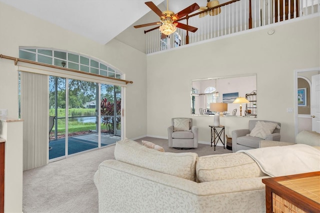11418 Tee Time Cir, New Port Richey, FL 34654 - carpeted living room featuring a ceiling fan, a high ceiling, and a water view