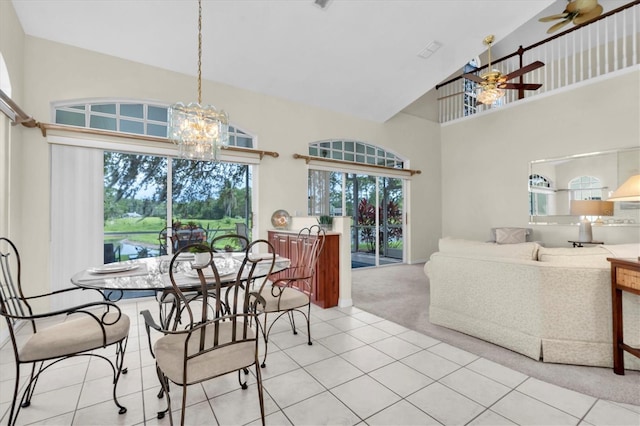 11418 Tee Time Cir, New Port Richey, FL 34654 - carpeted dining space featuring high vaulted ceiling, ceiling fan, a chandelier, and tile patterned flooring