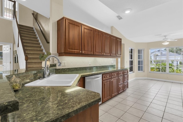 11418 Tee Time Cir, New Port Richey, FL 34654 - kitchen featuring stainless steel dishwasher, light tile patterned flooring, a ceiling fan, lofted ceiling, and tasteful backsplash