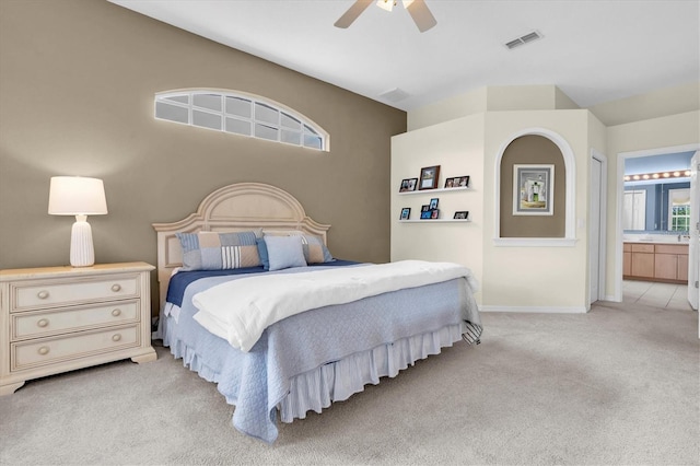 11418 Tee Time Cir, New Port Richey, FL 34654 - bedroom with light carpet, ensuite bath, and ceiling fan