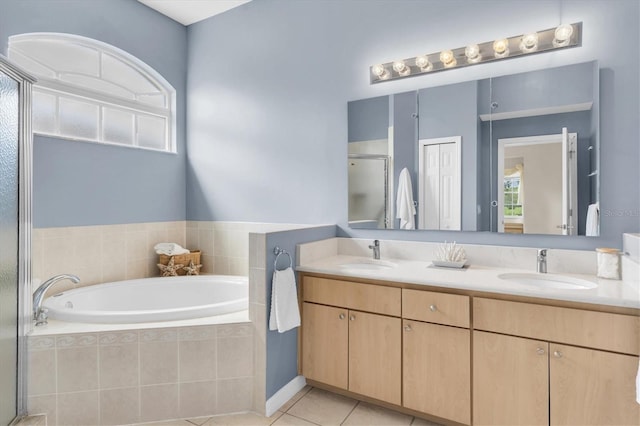 11418 Tee Time Cir, New Port Richey, FL 34654 - bathroom with double vanity, a bath, tile patterned flooring, and a stall shower