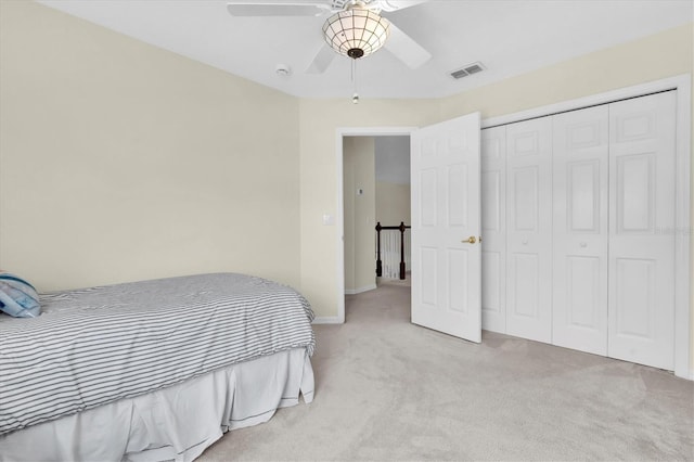 11418 Tee Time Cir, New Port Richey, FL 34654 - bedroom with carpet flooring, a closet, and a ceiling fan