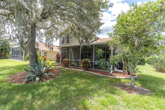 11418 Tee Time Cir, New Port Richey, FL 34654 - rear view of house with a sunroom and a lawn