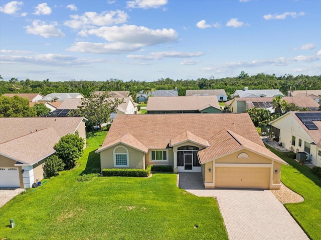 8401 Pavilion Dr, Hudson, FL 34667 - view of front of property featuring an attached garage, driveway, a residential view, stucco siding, and a front lawn