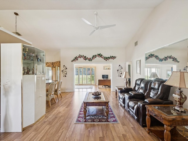 8401 Pavilion Dr, Hudson, FL 34667 - living room with light wood finished floors, ceiling fan, and high vaulted ceiling