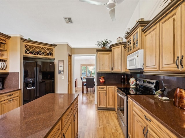 8401 Pavilion Dr, Hudson, FL 34667 - kitchen featuring electric range, white microwave, black fridge with ice dispenser, backsplash, and light wood finished floors