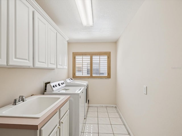 8401 Pavilion Dr, Hudson, FL 34667 - laundry room with cabinet space, washer and clothes dryer, light tile patterned floors, and a textured ceiling