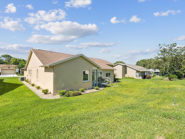 8401 Pavilion Dr, Hudson, FL 34667 - rear view of property with stucco siding and a yard