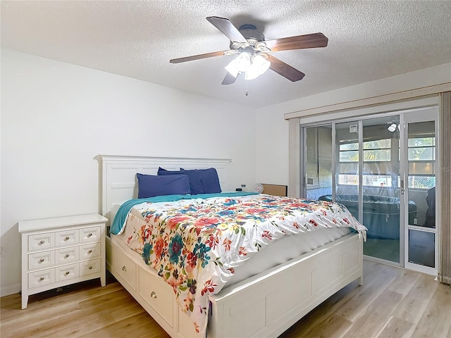 9425 Sterling Ln, Port Richey, FL 34668 - bedroom with access to outside, light wood-style floors, a textured ceiling, and ceiling fan