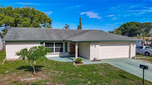 9425 Sterling Ln, Port Richey, FL 34668 - single story home with an attached garage, brick siding, a front yard, driveway, and roof with shingles