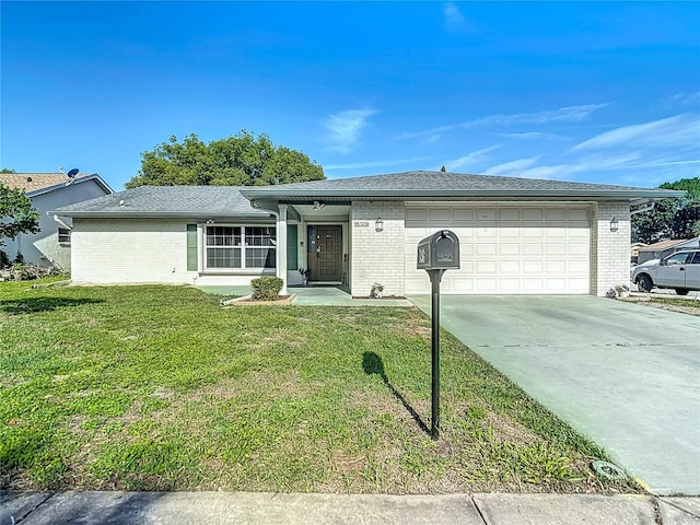 9425 Sterling Ln, Port Richey, FL 34668 - ranch-style home featuring concrete driveway, a garage, a front lawn, and brick siding