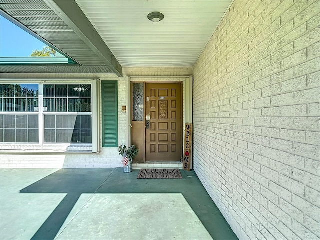 9425 Sterling Ln, Port Richey, FL 34668 - view of exterior entry featuring brick siding
