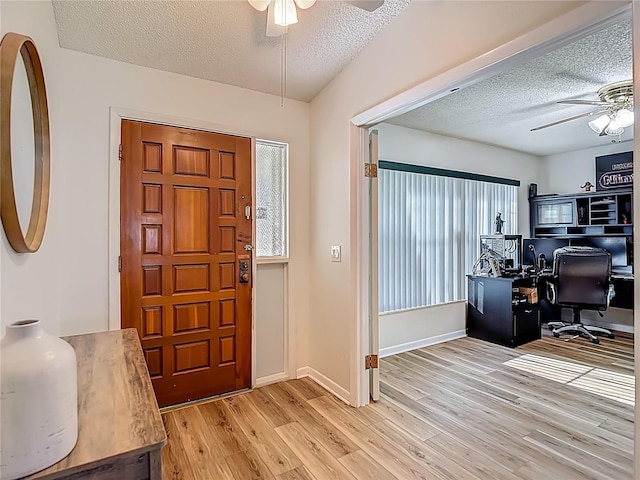 9425 Sterling Ln, Port Richey, FL 34668 - entrance foyer featuring ceiling fan, a textured ceiling, and light wood-type flooring