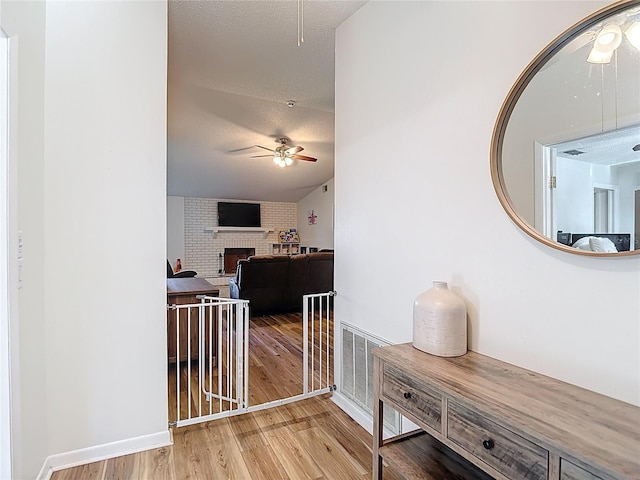 9425 Sterling Ln, Port Richey, FL 34668 - hallway featuring wood finished floors and a textured ceiling