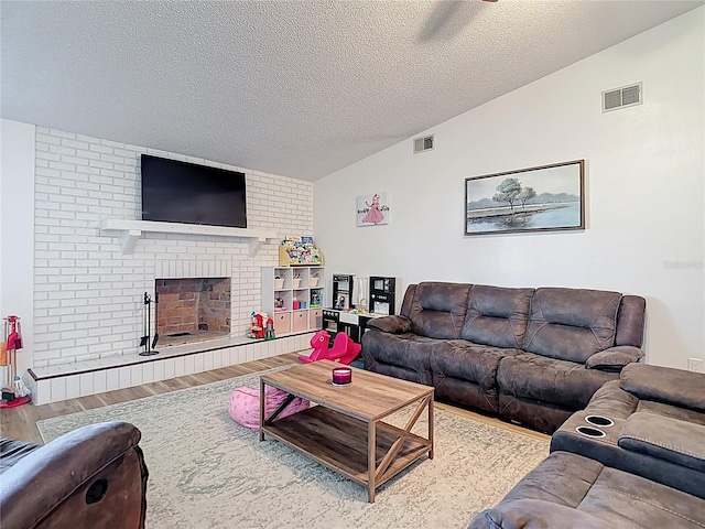 9425 Sterling Ln, Port Richey, FL 34668 - living room with lofted ceiling, wood finished floors, a textured ceiling, and a fireplace