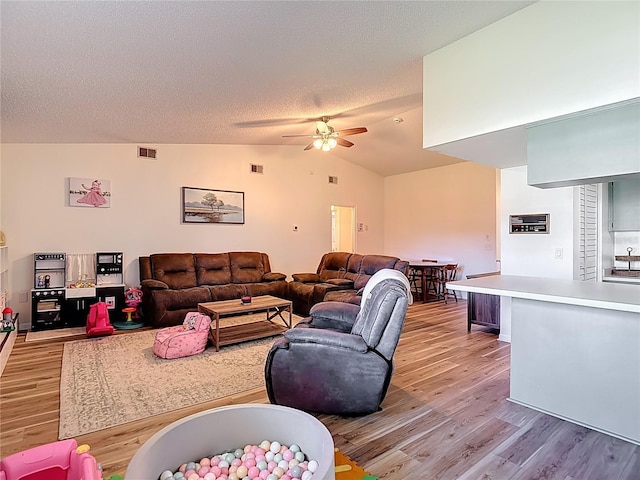 9425 Sterling Ln, Port Richey, FL 34668 - living area with light wood finished floors, a ceiling fan, lofted ceiling, and a textured ceiling