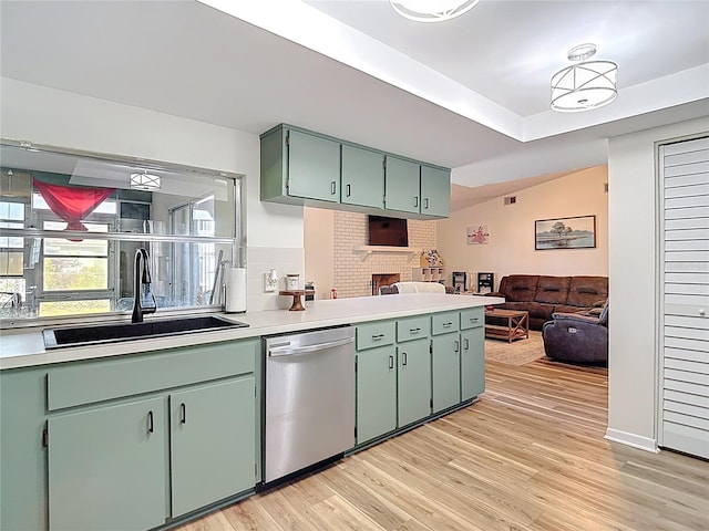 9425 Sterling Ln, Port Richey, FL 34668 - kitchen with dishwasher, open floor plan, light countertops, light wood-style floors, and a peninsula