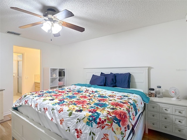 9425 Sterling Ln, Port Richey, FL 34668 - bedroom featuring wood finished floors, a ceiling fan, and a textured ceiling