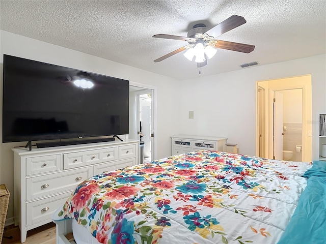 9425 Sterling Ln, Port Richey, FL 34668 - bedroom featuring light wood-type flooring, a textured ceiling, a ceiling fan, and ensuite bathroom
