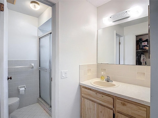 9425 Sterling Ln, Port Richey, FL 34668 - bathroom featuring a shower stall, vanity, tile patterned floors, tile walls, and backsplash
