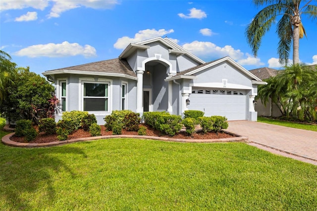 252 Arbor Woods Cir, Oldsmar, FL 34677 - ranch-style home featuring stucco siding, driveway, a front lawn, and a garage