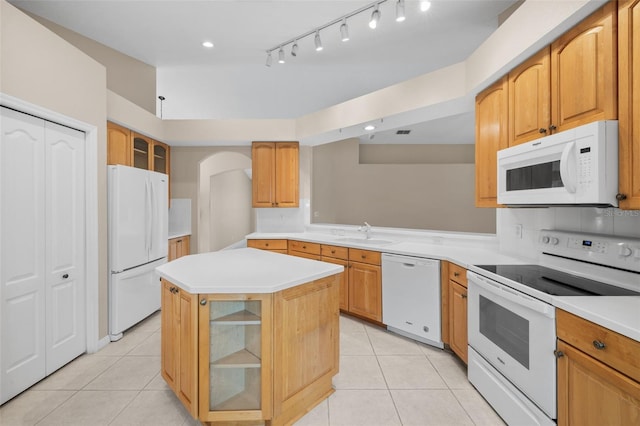 252 Arbor Woods Cir, Oldsmar, FL 34677 - kitchen with white appliances, light tile patterned floors, glass insert cabinets, light countertops, and a center island