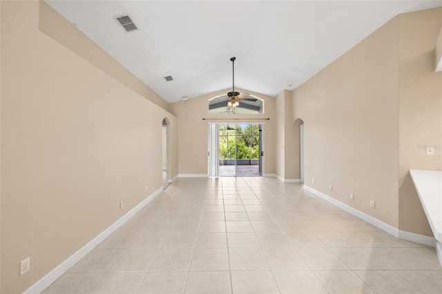 252 Arbor Woods Cir, Oldsmar, FL 34677 - spare room with arched walkways, a ceiling fan, light tile patterned floors, and lofted ceiling