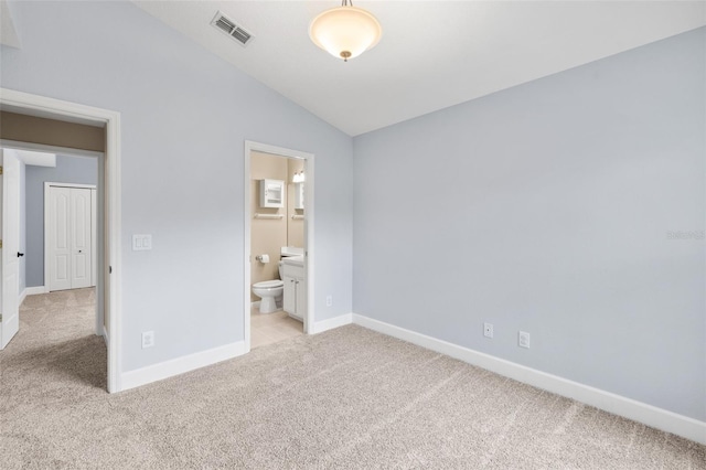 252 Arbor Woods Cir, Oldsmar, FL 34677 - unfurnished bedroom with light carpet, vaulted ceiling, and ensuite bath