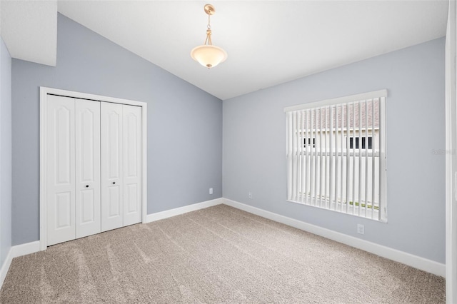 252 Arbor Woods Cir, Oldsmar, FL 34677 - unfurnished bedroom with carpet flooring, vaulted ceiling, and a closet