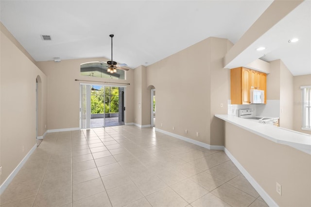 252 Arbor Woods Cir, Oldsmar, FL 34677 - unfurnished living room featuring arched walkways, light tile patterned flooring, a ceiling fan, lofted ceiling, and recessed lighting