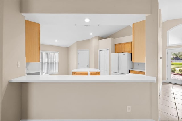 252 Arbor Woods Cir, Oldsmar, FL 34677 - kitchen with freestanding refrigerator, vaulted ceiling, light countertops, a center island, and recessed lighting