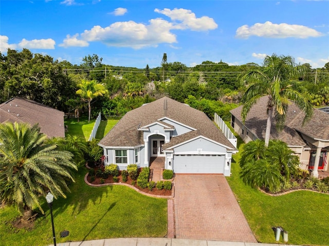 252 Arbor Woods Cir, Oldsmar, FL 34677 - view of front of property featuring an attached garage, decorative driveway, a front yard, and stucco siding