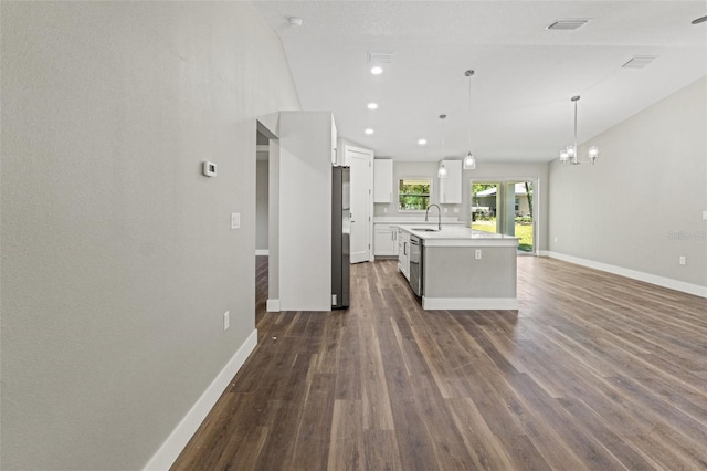 8782 N Sandree Dr, Citrus Springs, FL 34434 - kitchen featuring open floor plan, light countertops, white cabinets, dark wood-style floors, and a kitchen island with sink