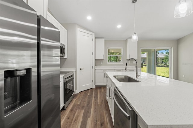 8782 N Sandree Dr, Citrus Springs, FL 34434 - kitchen with stainless steel appliances, dark wood-style flooring, white cabinets, a kitchen island with sink, and recessed lighting