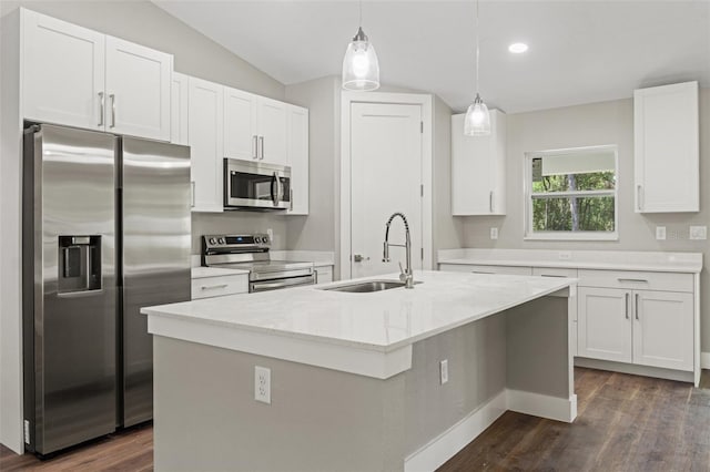 8782 N Sandree Dr, Citrus Springs, FL 34434 - kitchen with stainless steel appliances, dark wood-type flooring, white cabinetry, hanging light fixtures, and a kitchen island with sink